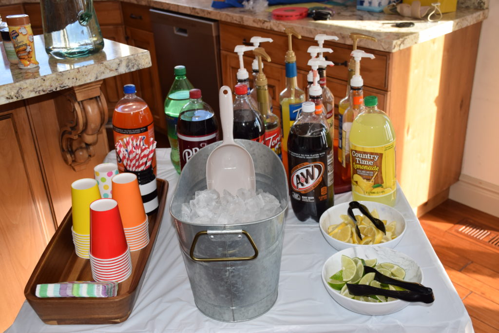 Soda bar set up with limes, lemons, ice and various sodas