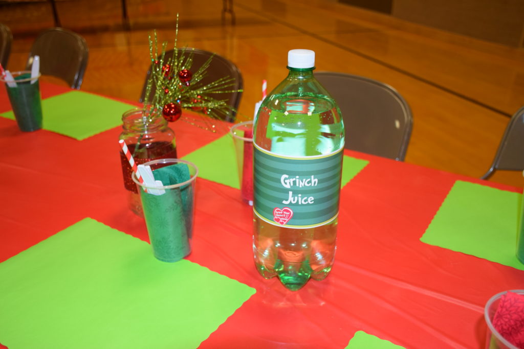 Close up of soda bottle wrapped with Grinch Juice paper