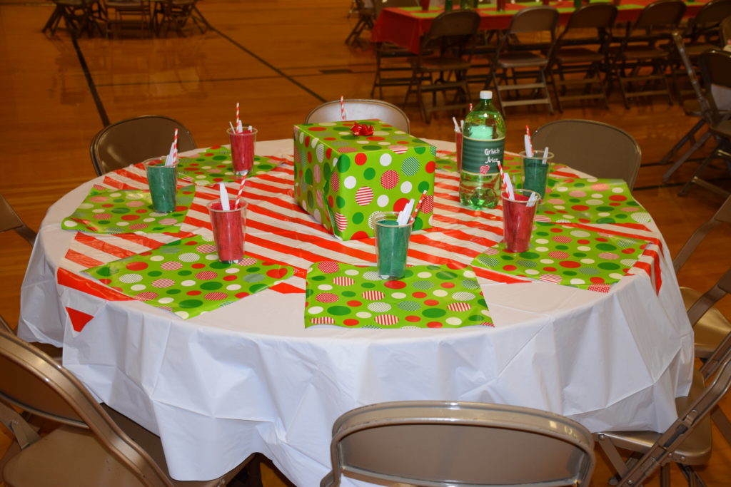 Table decorated with red and green with Grinch juice