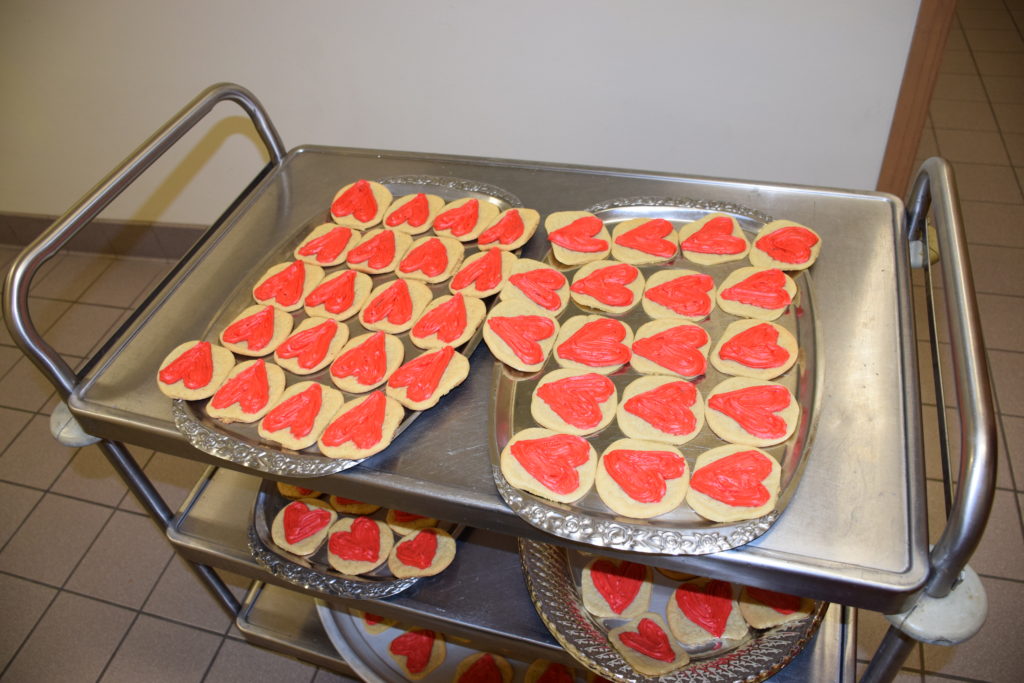 Sugar cookies with a heart made of red frosting