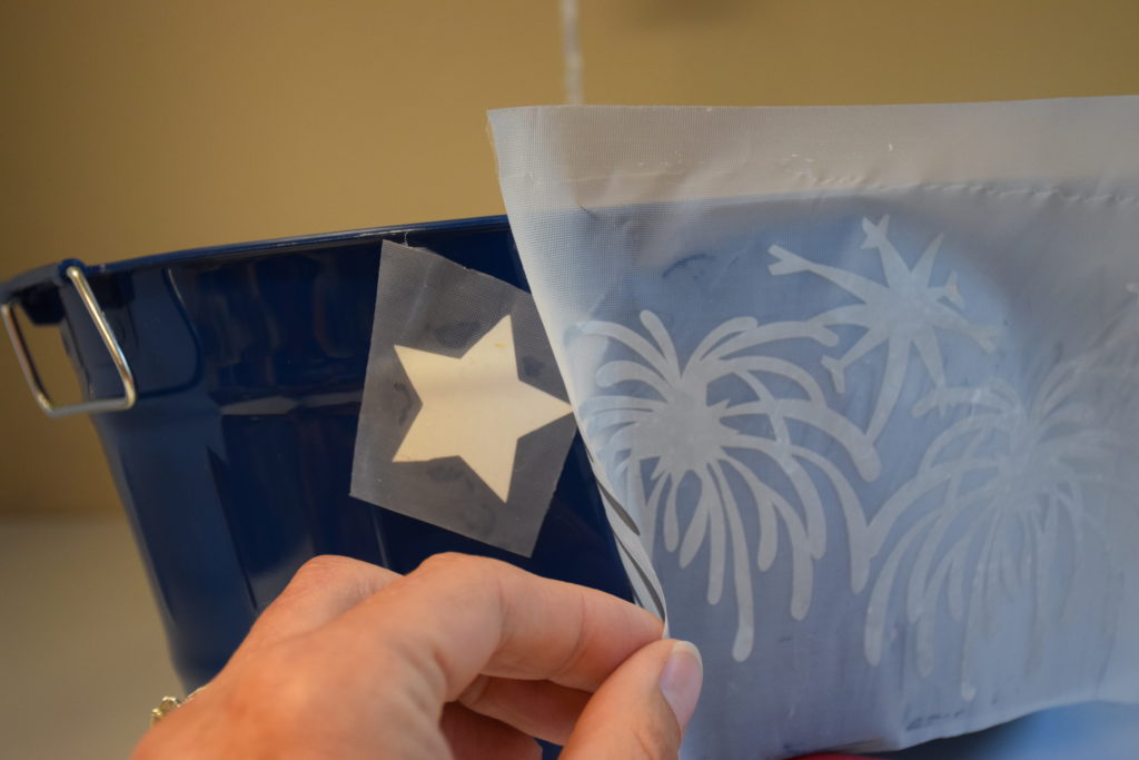 White vinyl stars being placed on bucket