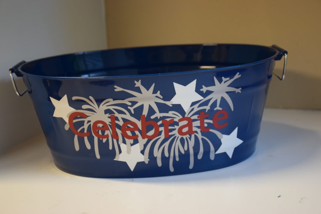 Blue bucket with silver fireworks, white stars and red lettering