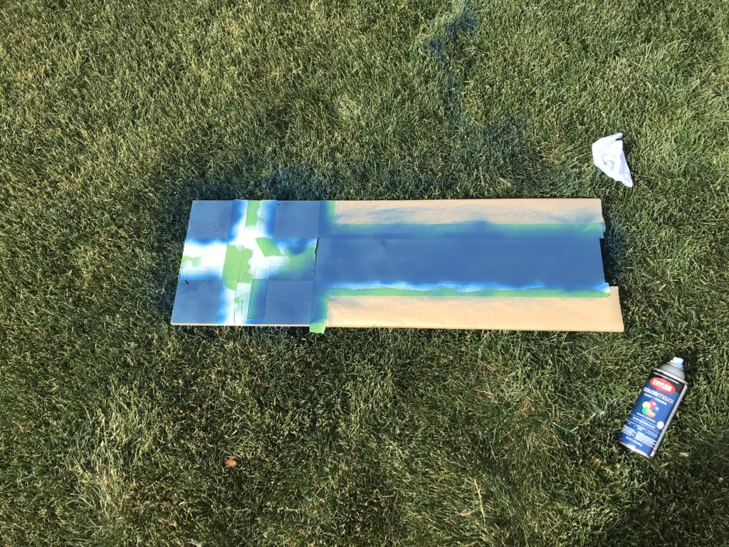 Cut board with taped squares painted blue