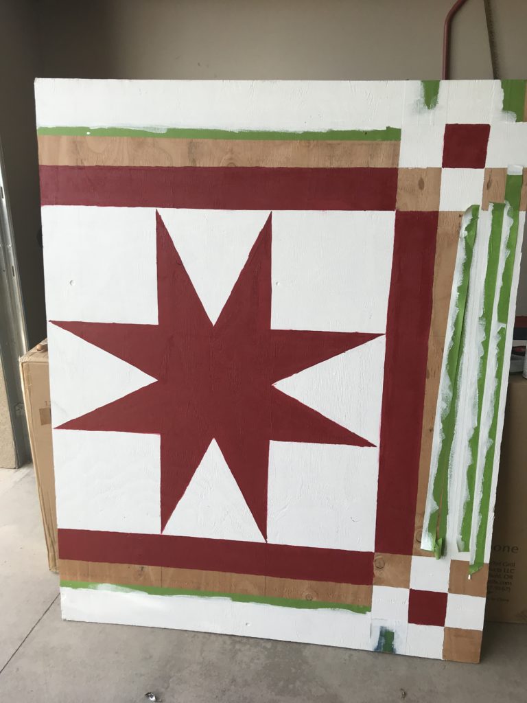 Board with a red star painted on it with white border