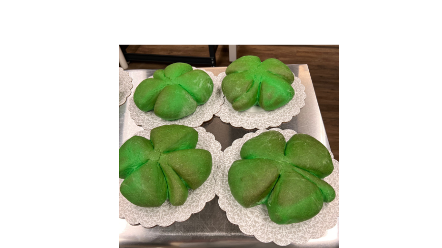 Four loaves of baked green shamrock bread