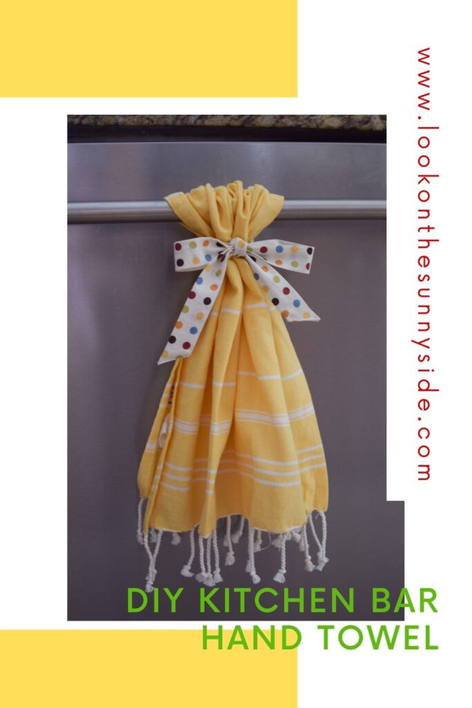 Yellow Hand Towel tied to the handle of the dishwasher