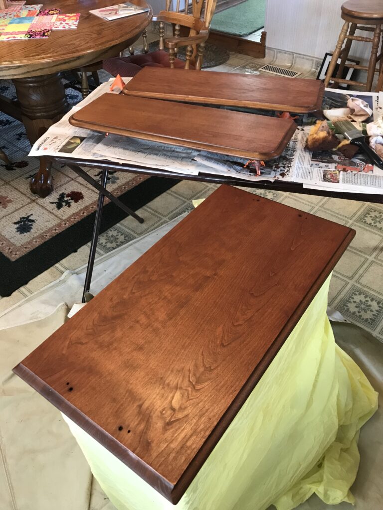 wooden table tops taken off of cart being stained