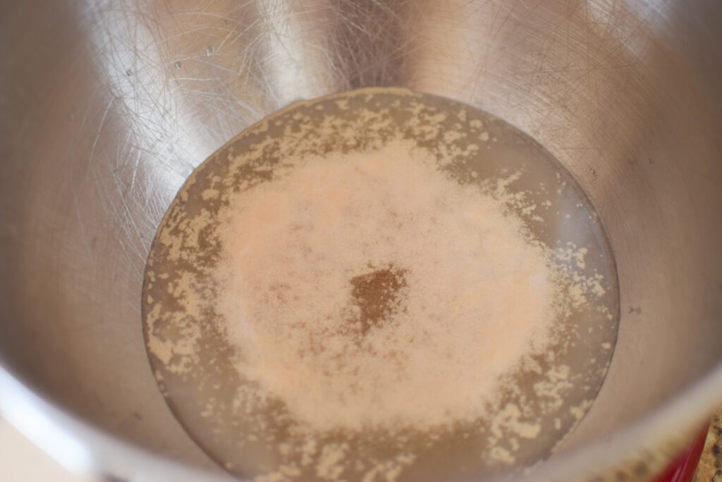 yeast, sugar and water in a bowl. Yeast getting bubbly