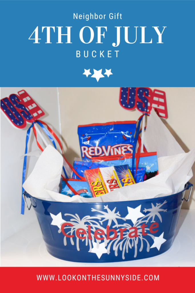 Blue bucket with vinyl stars, fireworks and word celebrate. Bucket is filled with sparklers, candy and banners