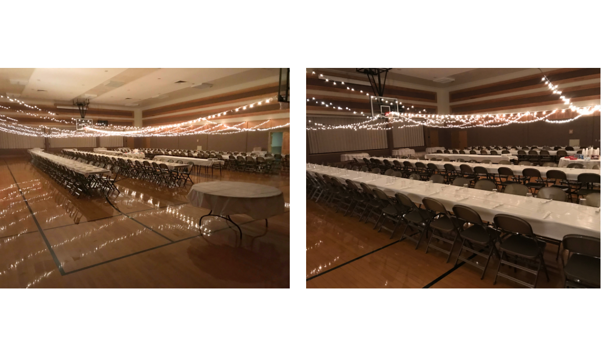 Lights strung over a gym for a party and tables set up end to end with chairs