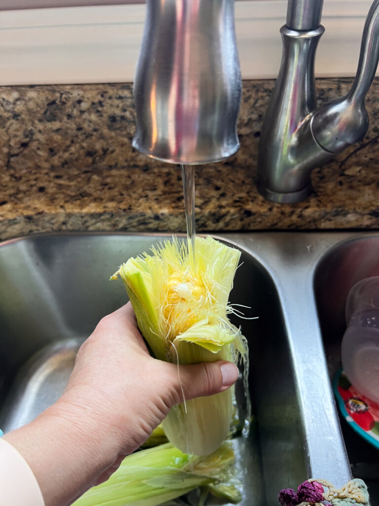 Water running into an ear of corn