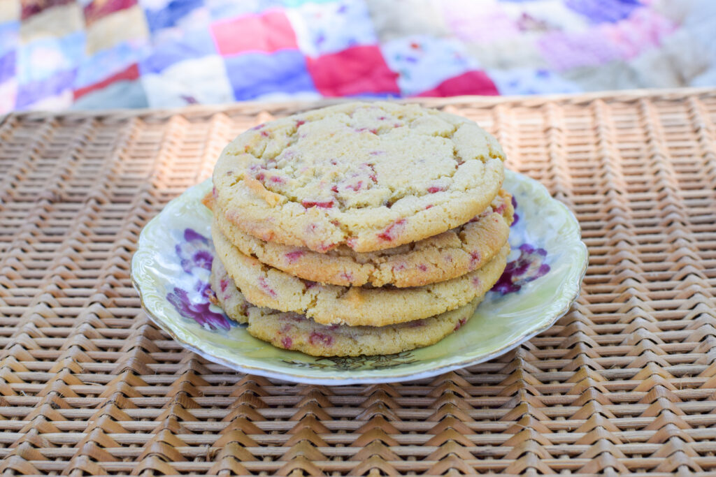 Strawberry lemonade cookies stacked on a plate on a picnic basket